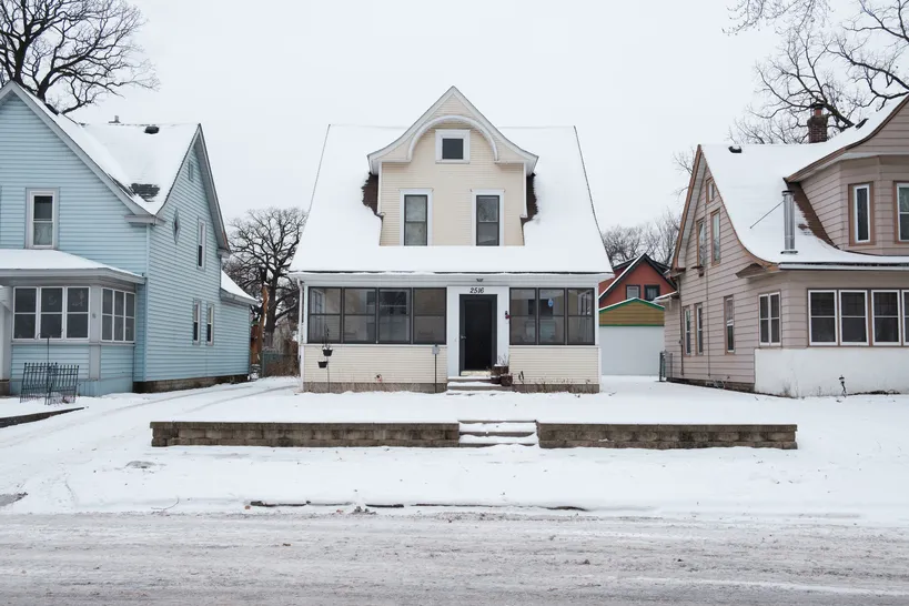 snow covered older minneapolis home