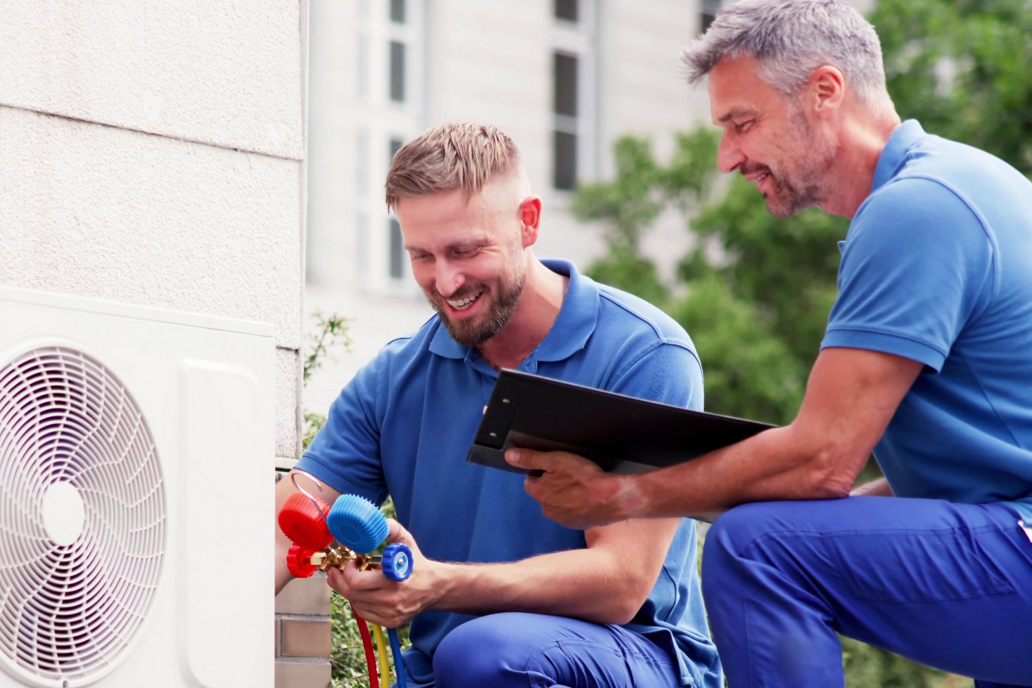 technicians are inspecting a HVAC unit