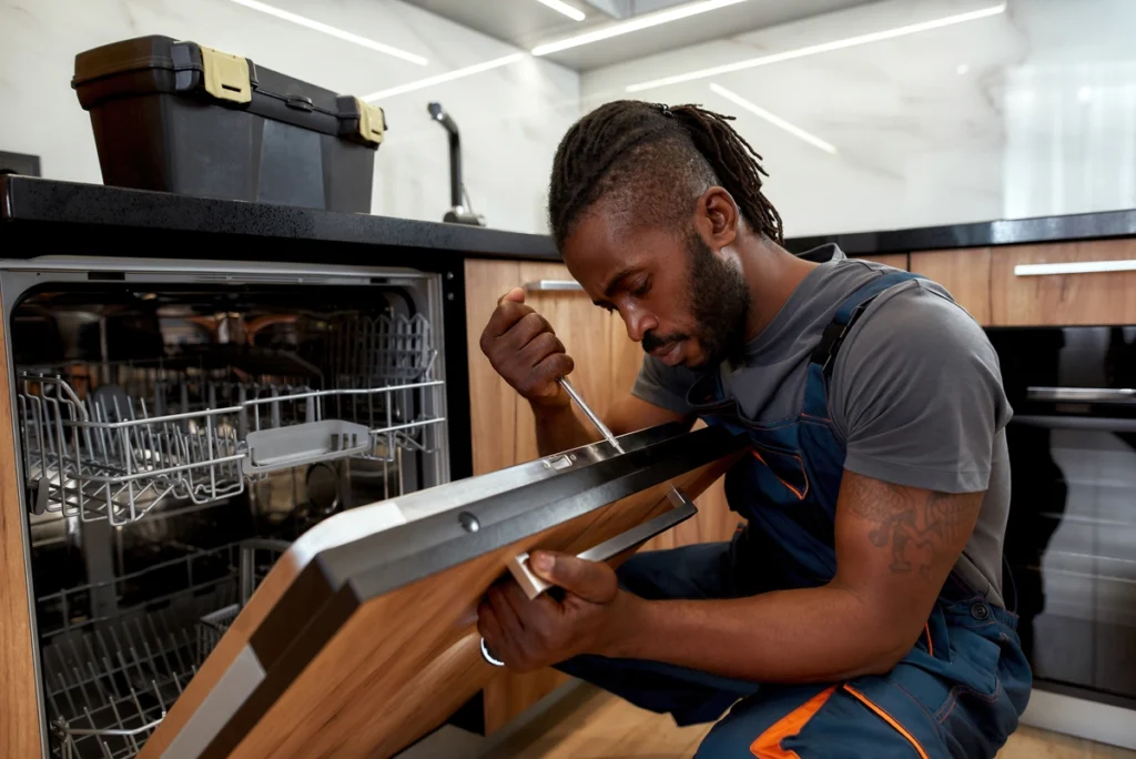 dishwasher being repaired by a repair tech