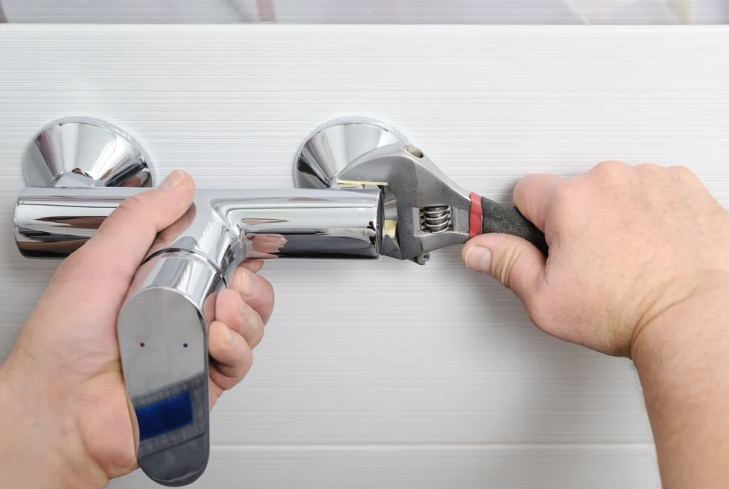 shower valve being installed with hand tools