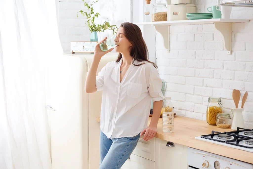 woman drinking a glass of water