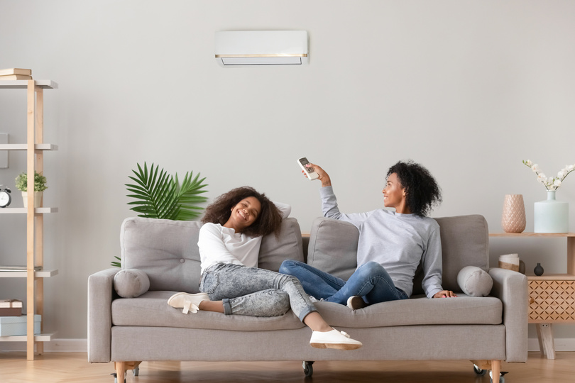 how does ac work-family sitting on a couch enjoying the air conditioning