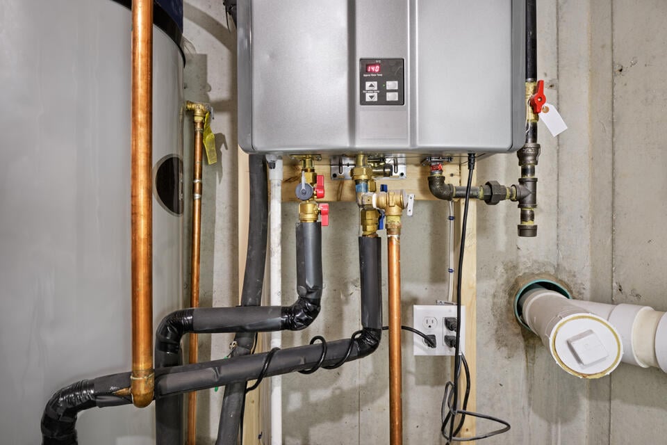tankless water heater installation-tankless water heater system on a wall in a basement