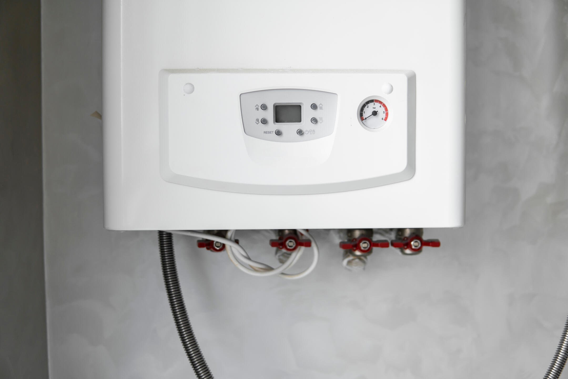 tankless water heater installation-white tankless water heater mounted to a wall