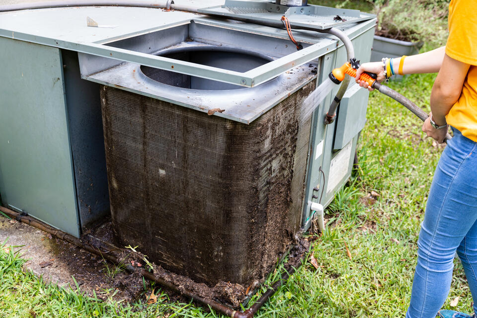 ac tune up cost-regular maintenance of HVAC system by spraying down outdoor AC filters