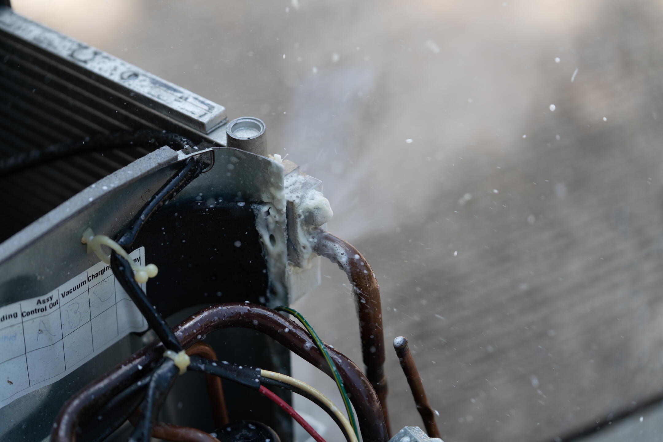refrigerant leak-close up image of an AC unit leaking freon refrigerant