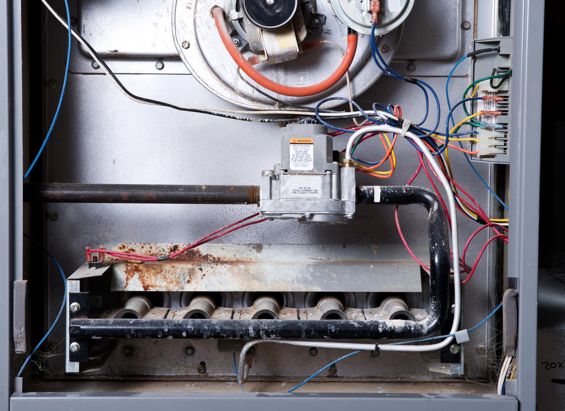 gas furnace replacement cost-close up of furnace parts needing maintenance or replacement