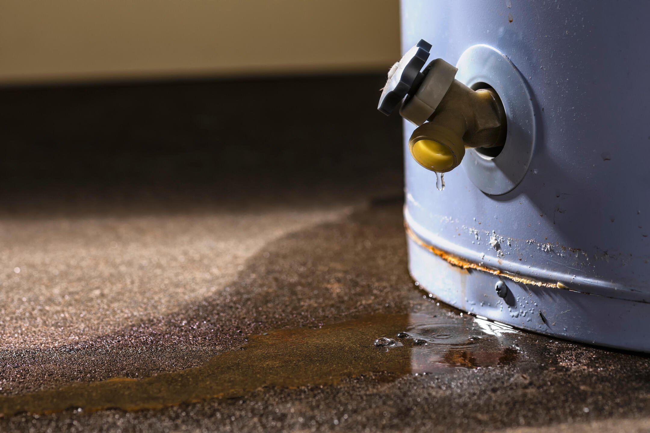 hot water heater leaking-close up of water heater tank leaking