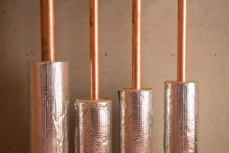 pipe insulation-reflective insulation around copper pipes inside a home