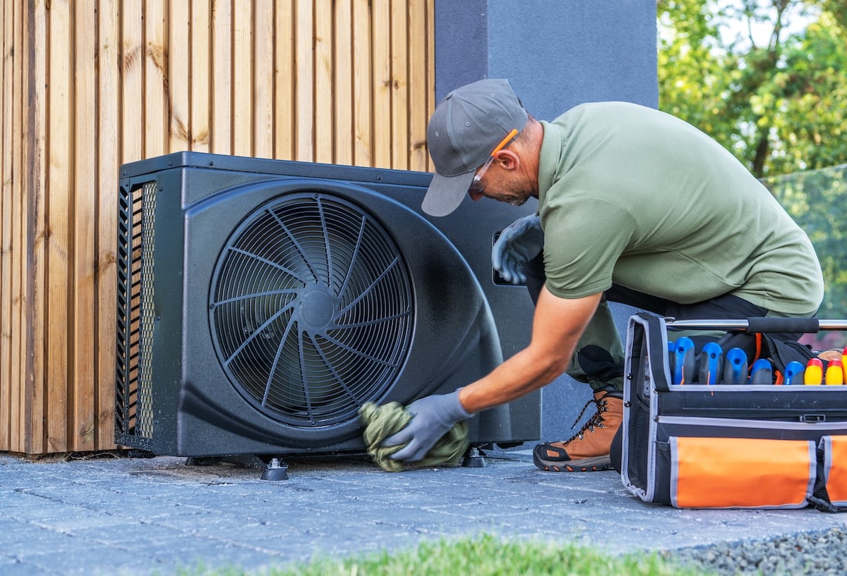 Technician Performs Maintenance on Outdoor Air Conditioning Unit