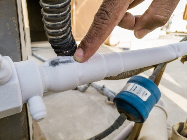 ice formation the AC compressor pipe is connected into a heavy ac unit and it's fully covered by ice and black dusty power cables are around it