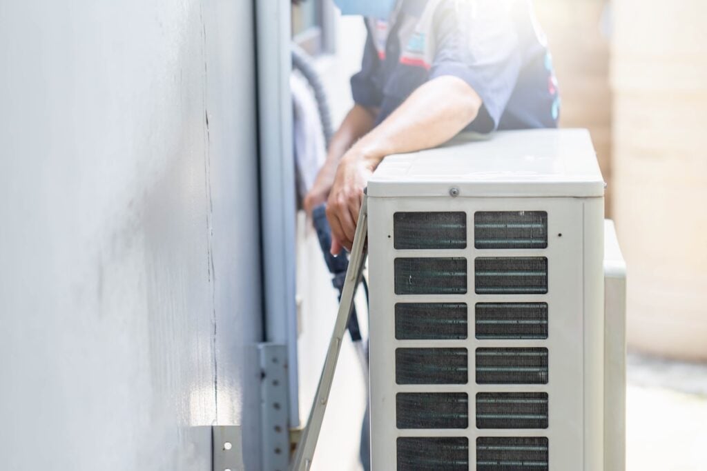 Selective focus of Air conditioner compressor, Repairman washing dirty compartments air conditioner, Male technician cleaning air conditioner indoors ac compressor replacement