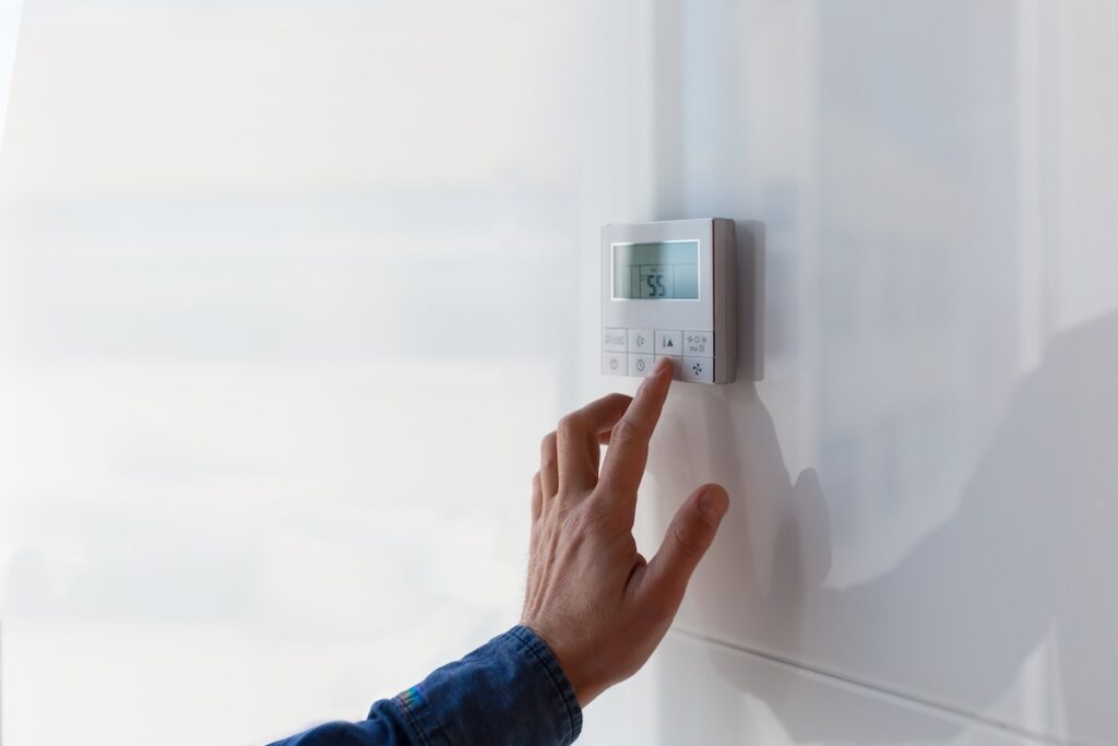thermostat replacement The air conditioning and heating control panel for the apartment and office is located on a white wall.